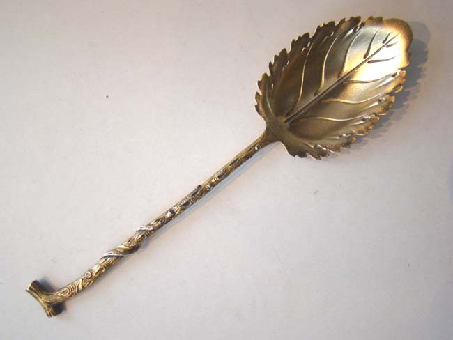 An unusual 19th century silver gilt serving spoon in the form of a branch and a leaf.